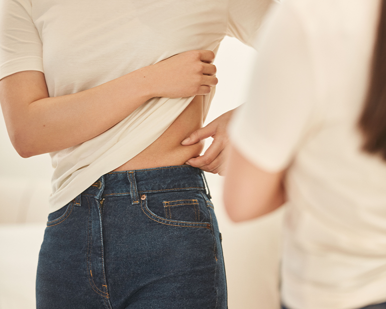 expert assessing a woman's belly area